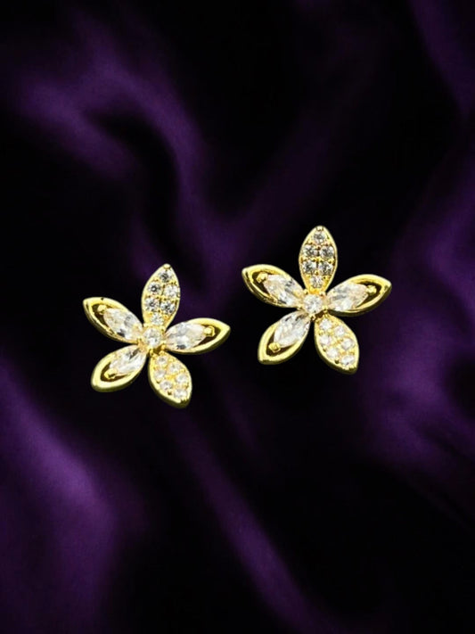 SHE BEAUTY LUXE BLOSSOM gold-tone flower stud earrings with sparkling clear cubic zirconia stones on purple silk