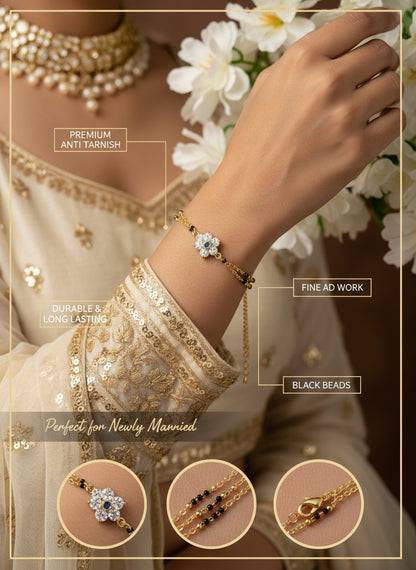 SHE BEAUTY anti-tarnish mangalsutra bracelet featuring a floral AD stone charm and black beads on a gold chain.