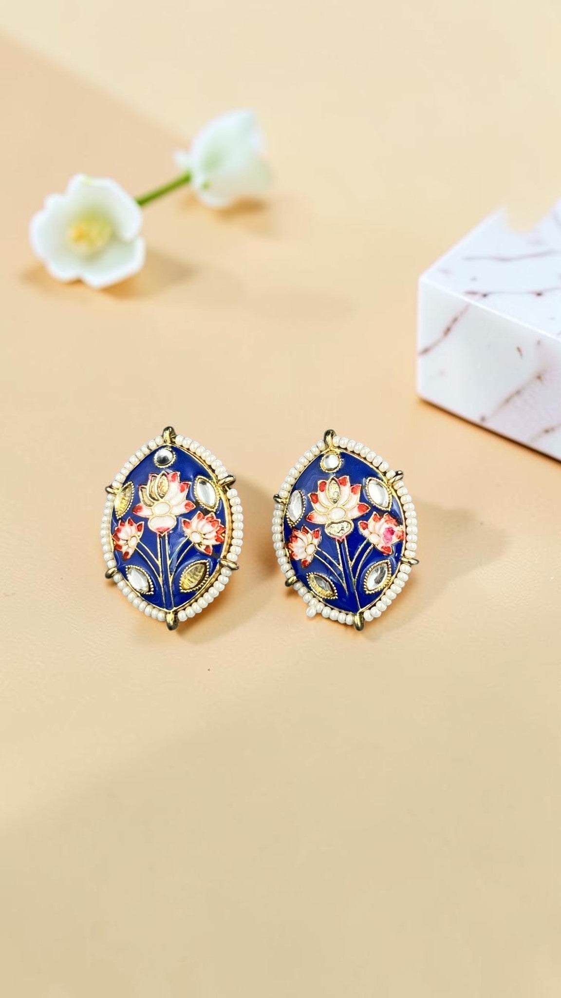SHE BEAUTY Meenakari tops featuring blue enamel, floral lotus motifs, and pearl detailing for festive ethnic wear.