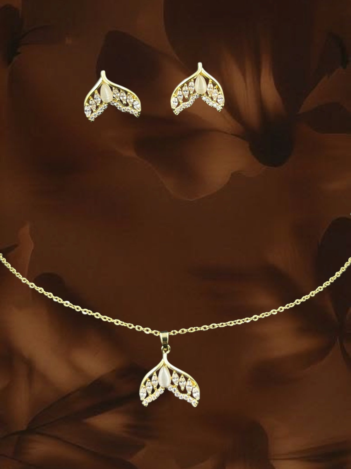 SHE BEAUTY mermaid pendant set featuring gold-tone metal, white stones, and matching stud earrings for festive wear.
