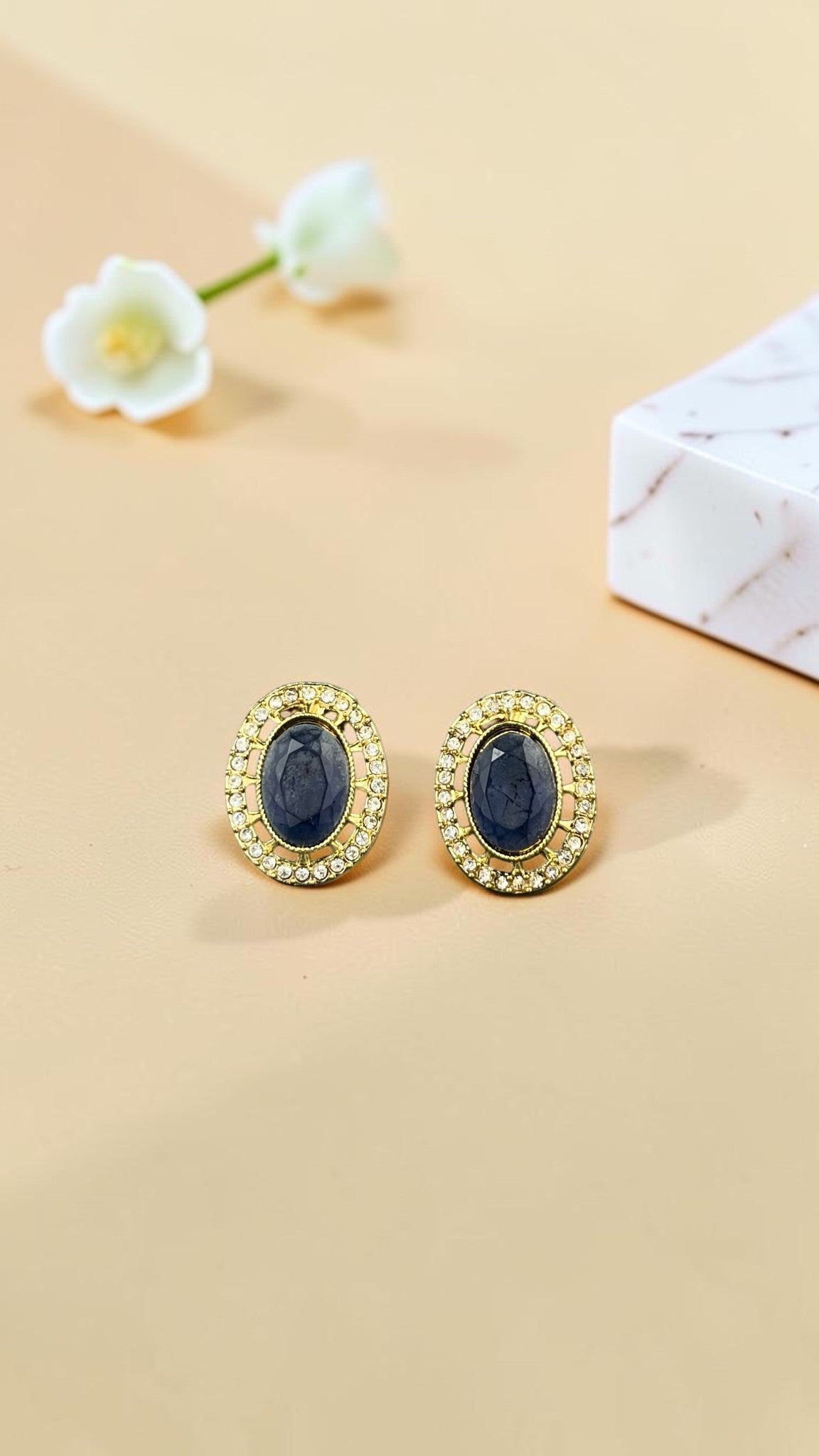SHE BEAUTY AD antique stud earrings featuring oval blue stones surrounded by a halo of sparkling white crystals