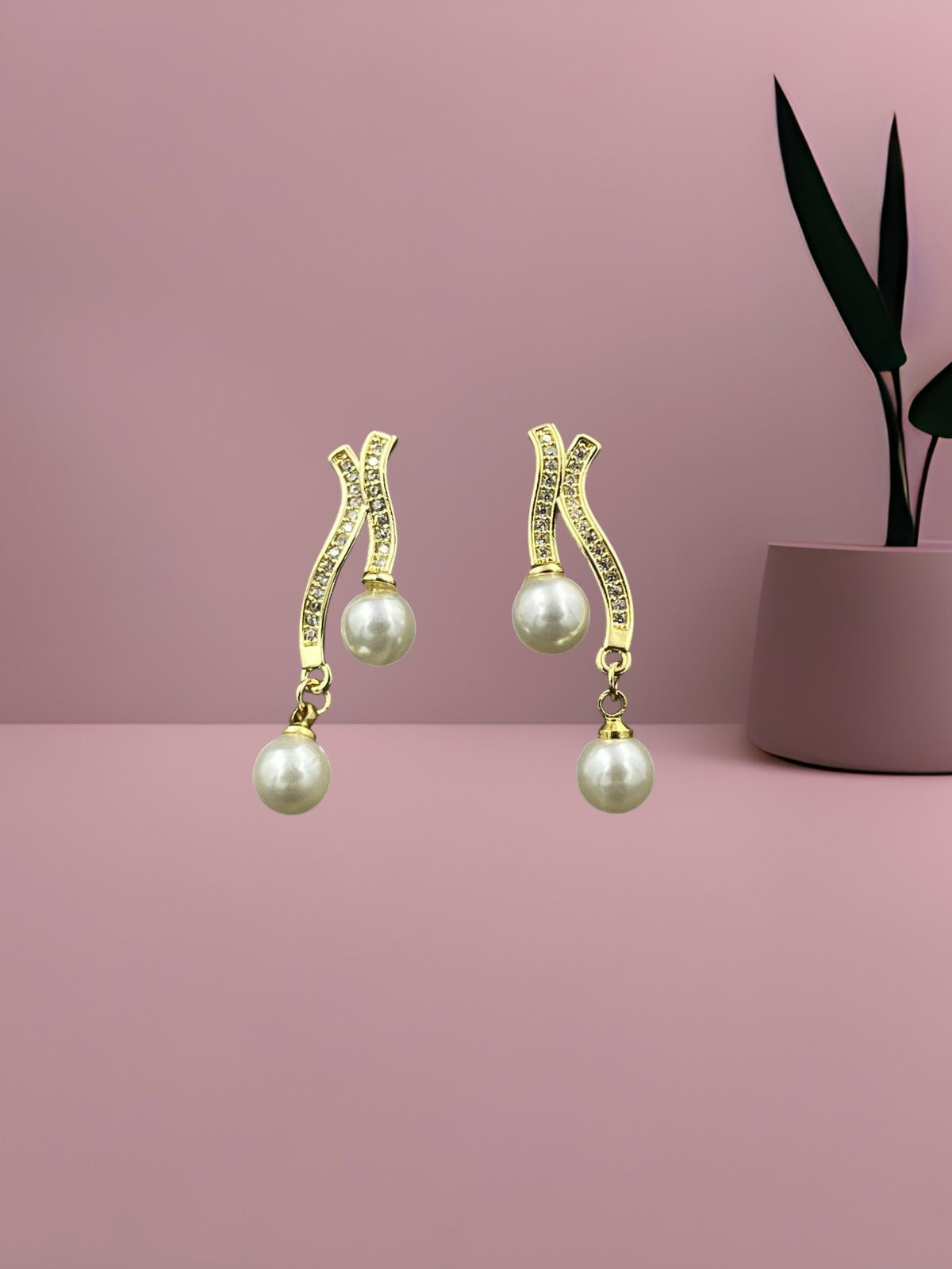 SHE BEAUTY gold-tone drop earrings featuring wavy crystal-encrusted stems and dual white pearl accents.