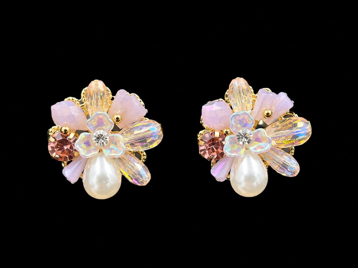 SHE BEAUTY PEARL FANTASY floral stud earrings with pink crystals, iridescent petals, and a central faux pearl.