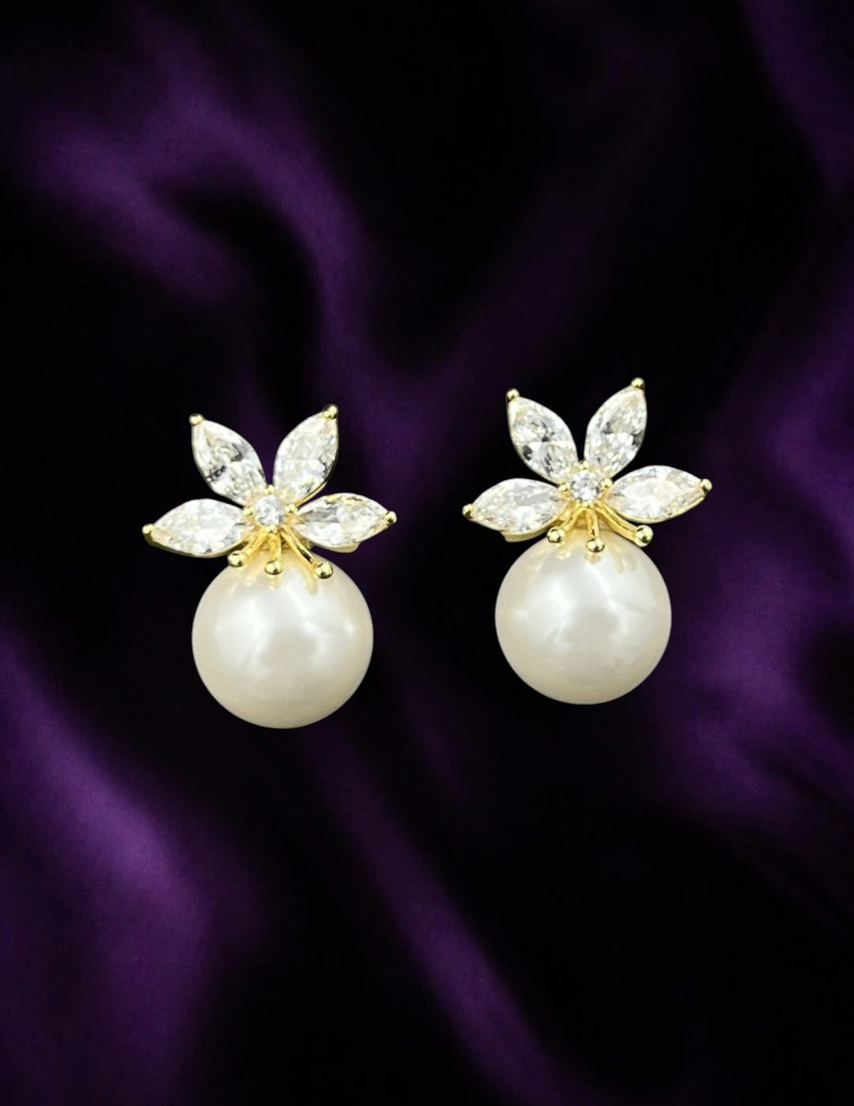 SHE BEAUTY Pearl Ad Petal earrings featuring white pearls and marquise-cut cubic zirconia petals on a purple fabric