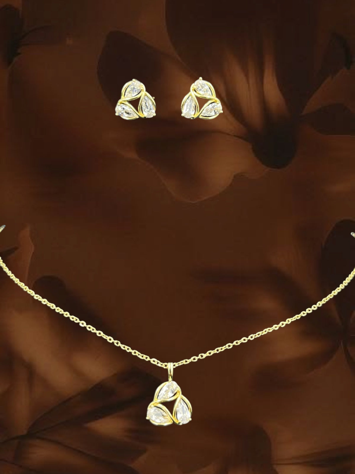 SHE BEAUTY AD petal pendant and matching stud earrings set with clear stones in a gold-toned finish