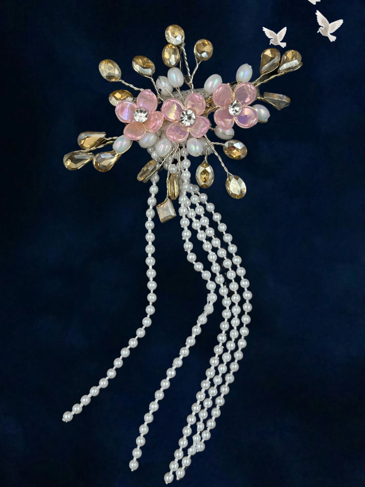 SHE BEAUTY hair pin featuring three pink blossoms, crystal accents, and elegant hanging pearl tassels for festive wear.