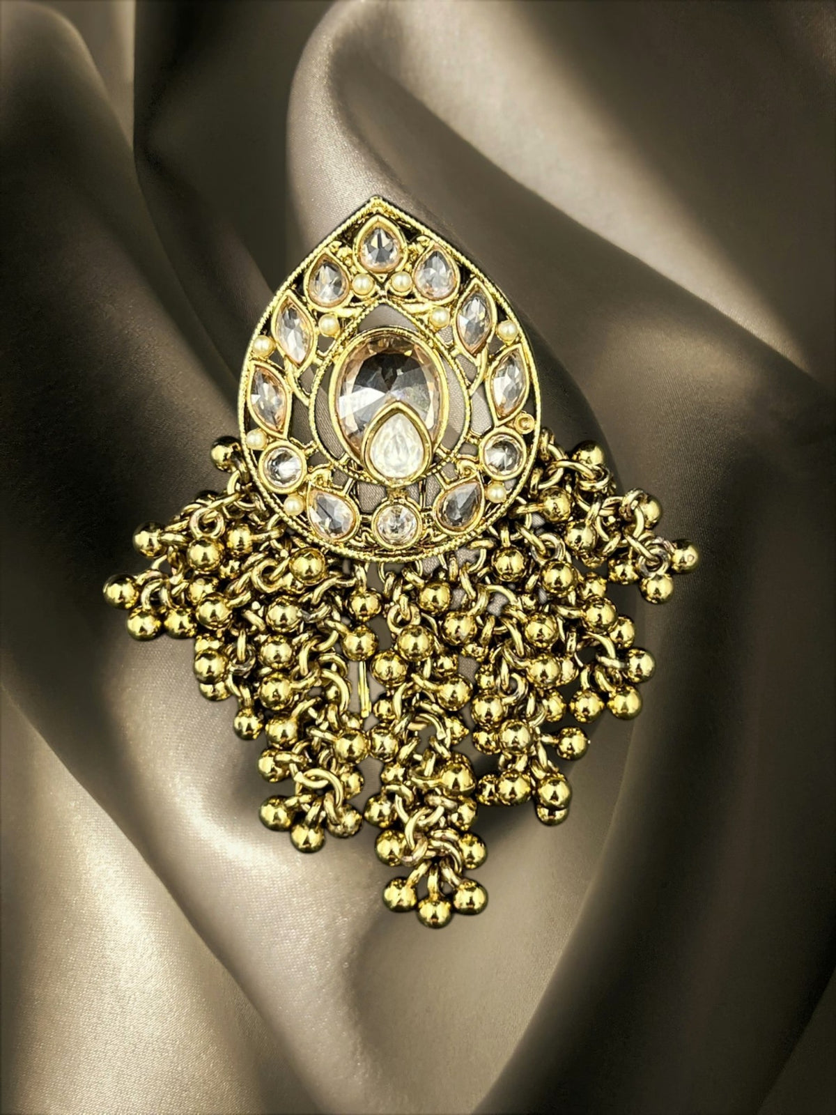 SHE BEAUTY drop polki juda hair brooch with gold-tone metal, clear stones, and dangling metallic bead clusters.