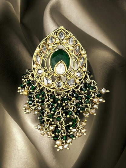 SHE BEAUTY drop polki juda hair brooch featuring a central green stone, clear crystals, and beaded gold-tone tassels.