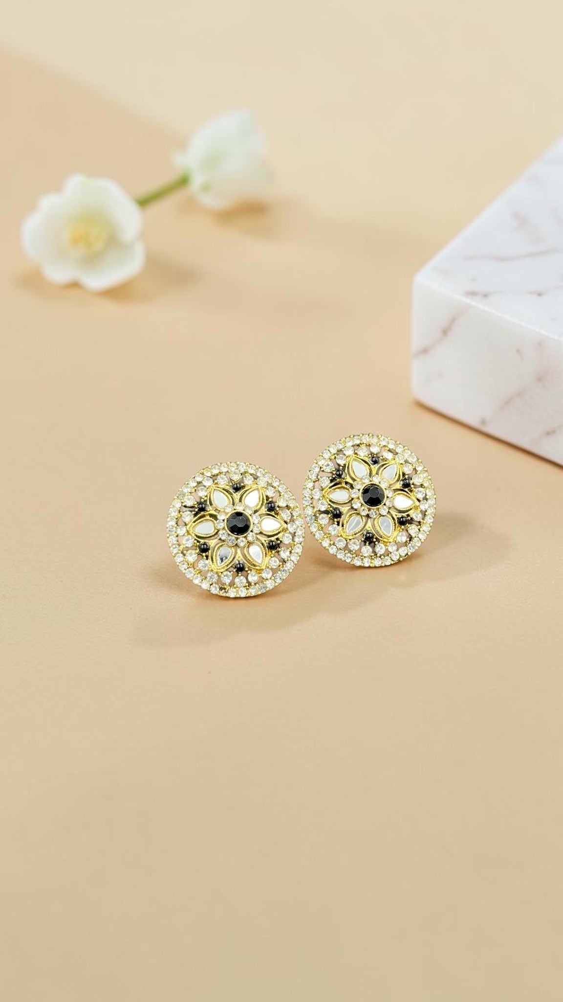 SHE BEAUTY round mirror stone tops featuring intricate floral patterns with white and black accents for festive wear.