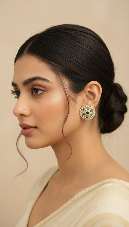 SHE BEAUTY round mirror stone tops with intricate floral design worn by a woman in a side profile view
