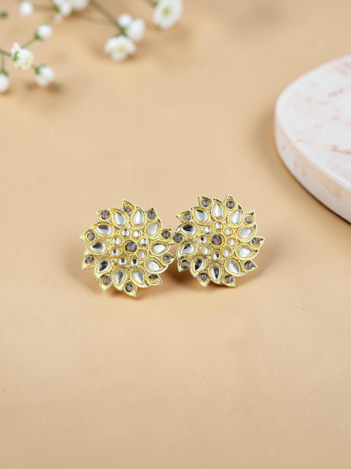 SHE BEAUTY Royal Kundan gold stud earrings with a floral design, featuring clear stones in a traditional finish.