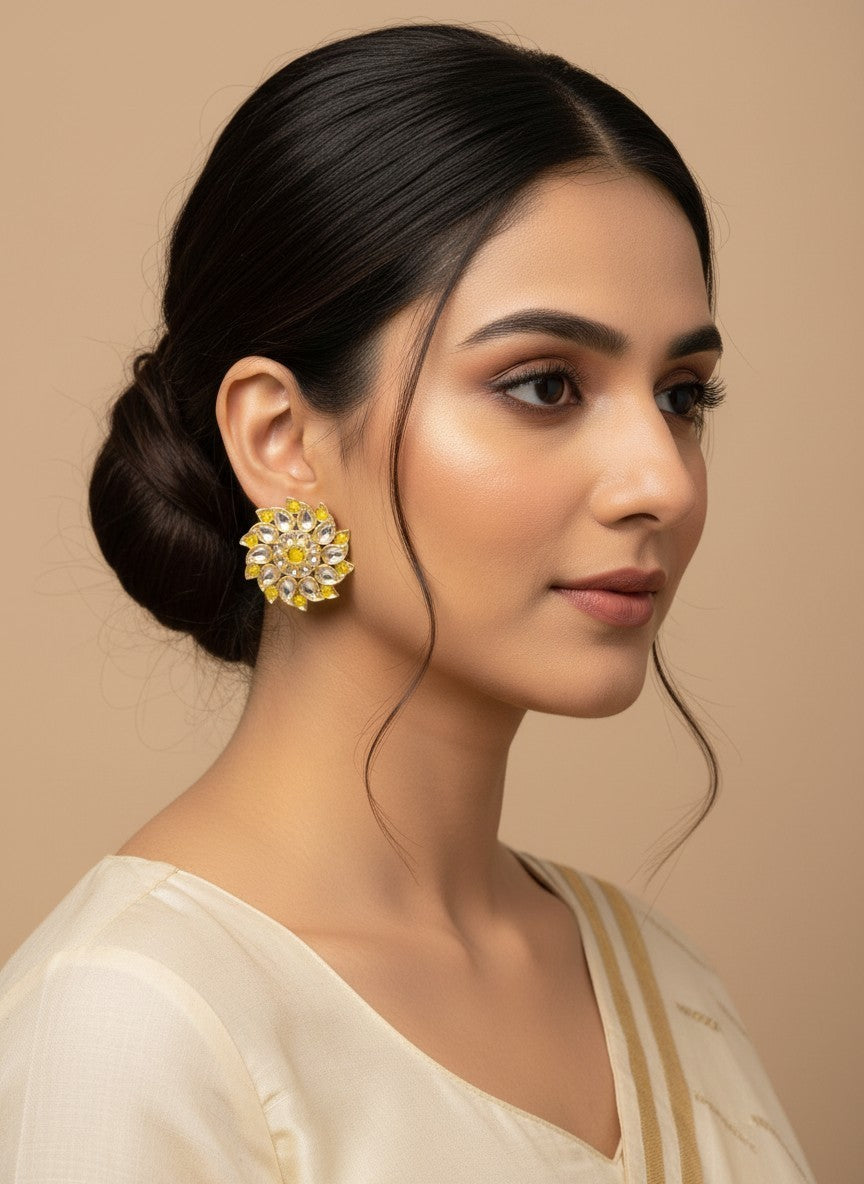 SHE BEAUTY Royal Kundan gold tops featuring a floral design with yellow and clear stones worn by a woman in a bun.