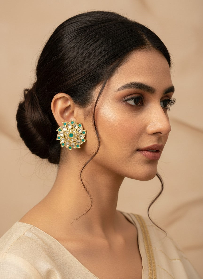 SHE BEAUTY Royal Kundan gold tops featuring a floral design with green stones worn by a woman in profile