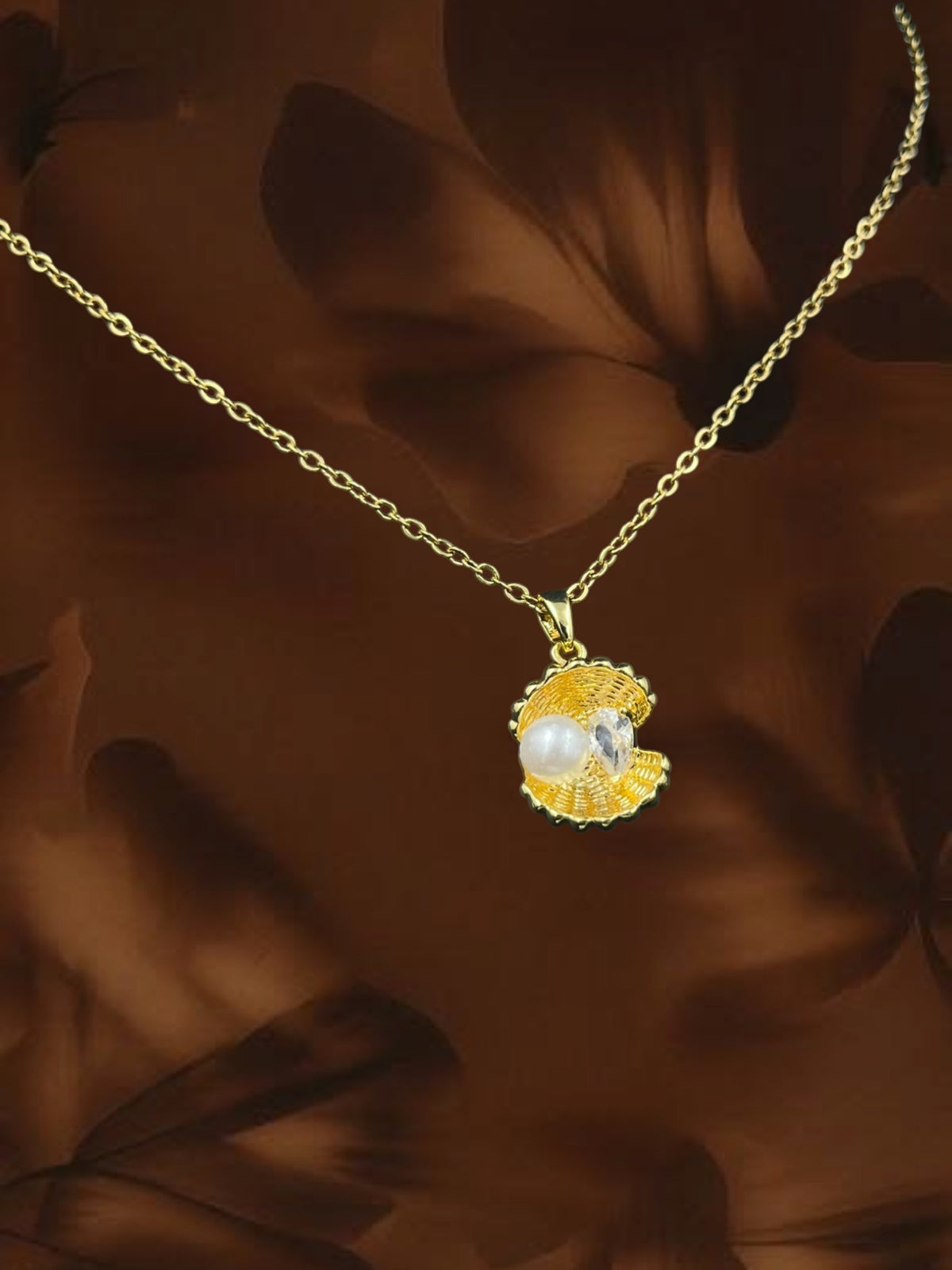 SHE BEAUTY gold-toned seashell pendant necklace featuring a white pearl and sparkling crystal accent