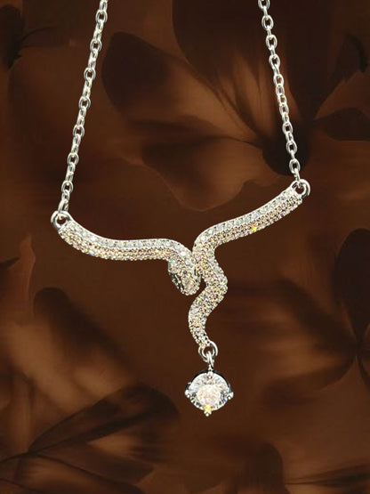 SHE BEAUTY luxe serpent pendant necklace featuring a silver-tone snake design encrusted with sparkling clear crystals