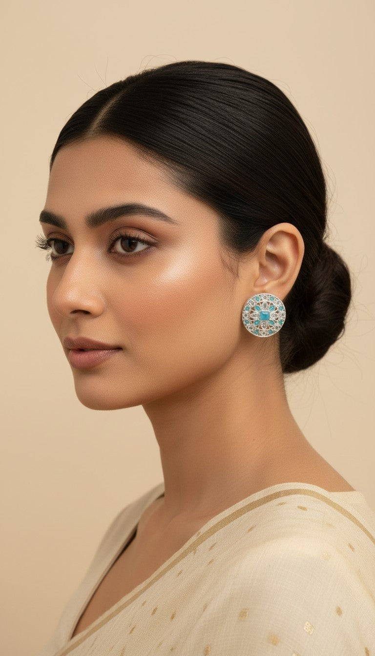 SHE BEAUTY silver AD tops featuring intricate filigree work and a central blue stone worn by a woman.