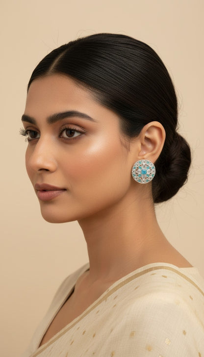SHE BEAUTY silver AD tops featuring intricate filigree work and a central blue stone worn by a woman.