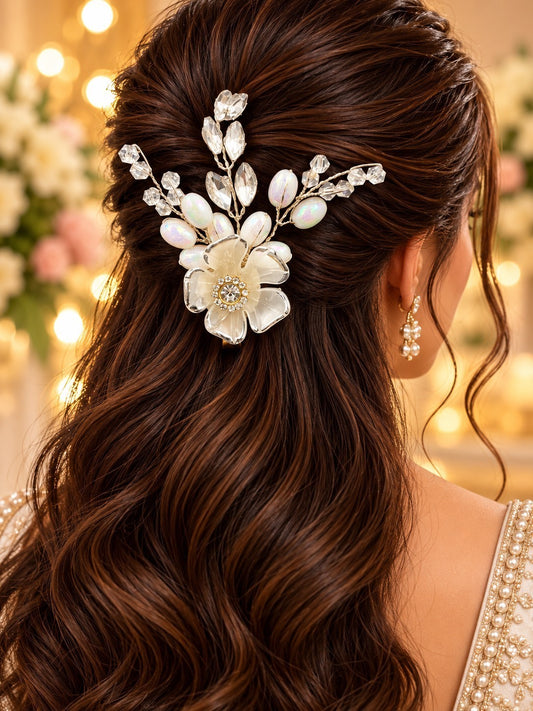 SHE BEAUTY silver blossom hair pin with white pearls and crystals worn in a woman's wavy brown hair for festive wear.