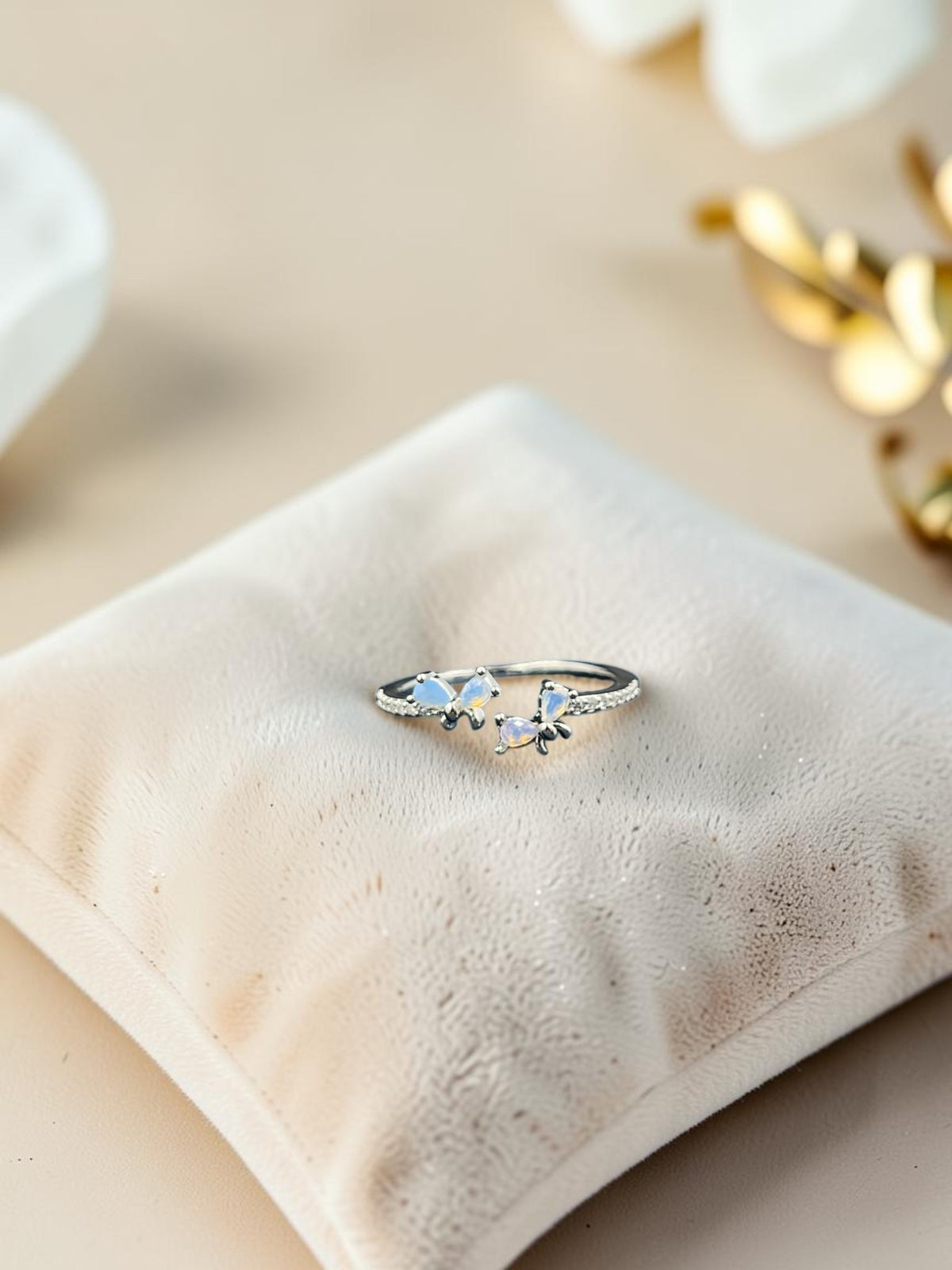 SHE BEAUTY sterling silver open ring featuring two delicate butterfly motifs with iridescent opal-like stones