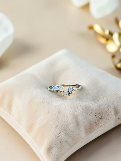 SHE BEAUTY sterling silver open ring featuring two delicate butterfly motifs with iridescent opal-like stones