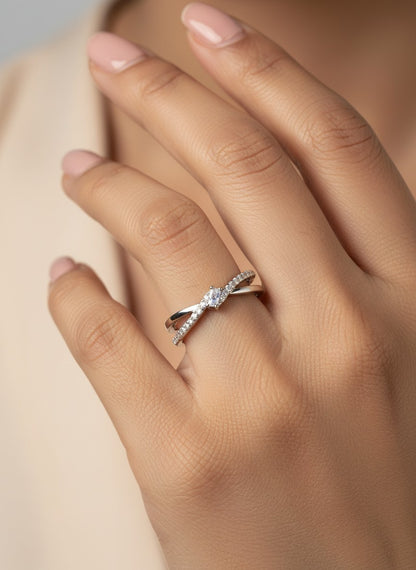 SHE BEAUTY sterling silver crossover ring with a central cubic zirconia stone worn on a woman's finger