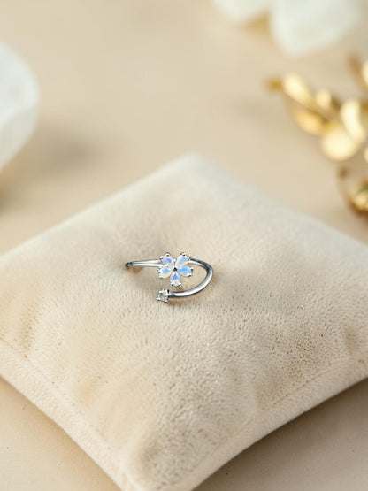 SHE BEAUTY sterling silver open ring featuring a delicate flower design with iridescent opal petals and a small stone