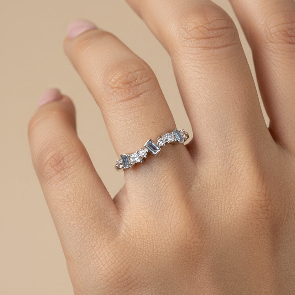 SHE BEAUTY sterling silver girlish ring featuring alternating baguette and round cut clear stones on a woman's finger