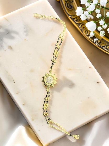 SHE BEAUTY anti-tarnish gold-toned mangalsutra bracelet featuring a sunflower charm with sparkling AD stones