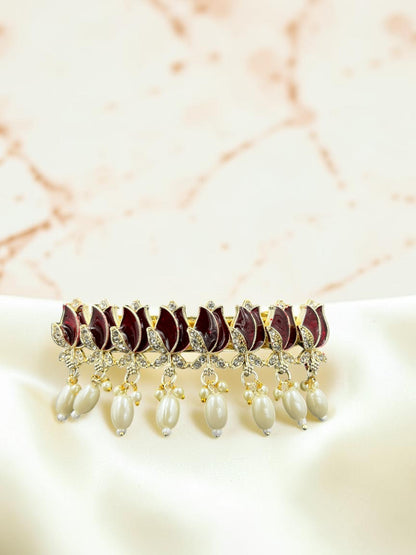 SHE BEAUTY AD Tulip Meenakari pearl barrette featuring maroon enamel floral motifs and dangling white pearl accents.