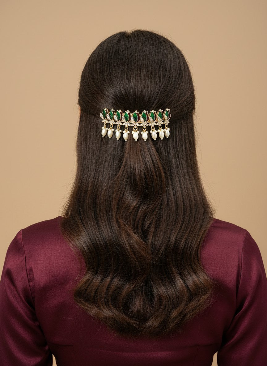 SHE BEAUTY AD tulip meenakari barrette with green stones and hanging white pearls worn in long wavy brown hair