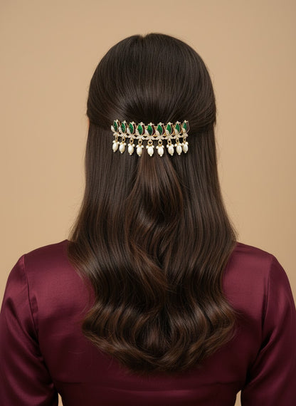 SHE BEAUTY AD tulip meenakari barrette with green stones and hanging white pearls worn in long wavy brown hair
