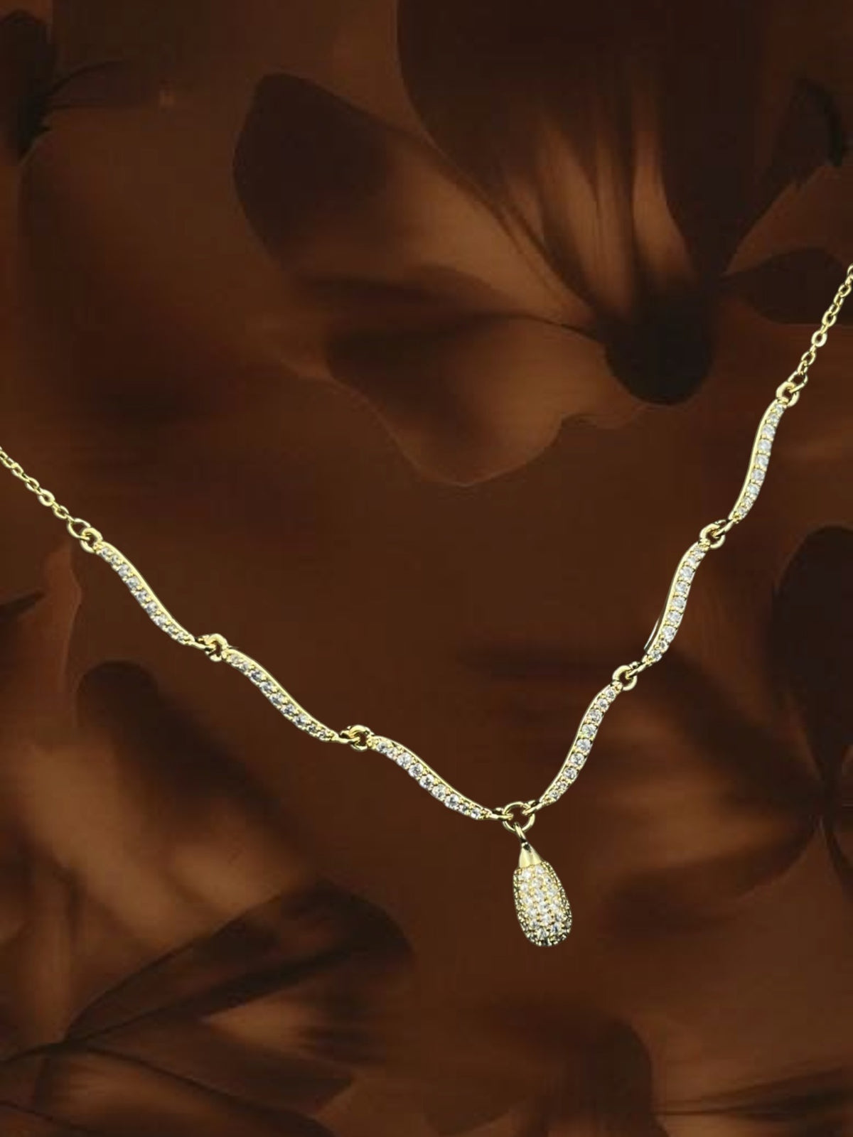 SHE BEAUTY gold-tone twist drop pendant necklace featuring delicate pavé-set crystals for a festive party look.