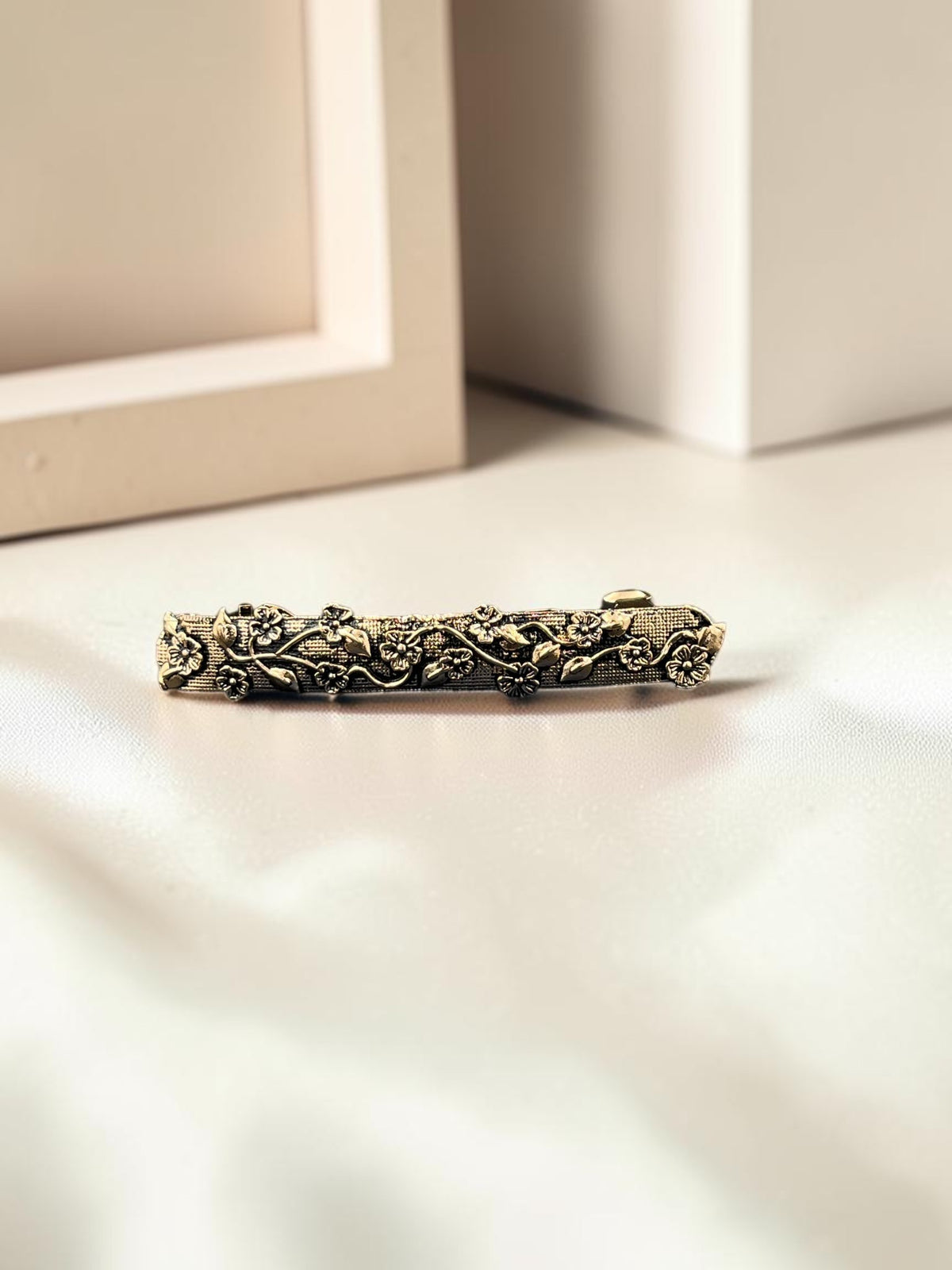 SHE BEAUTY vine vintage metallic barrette with intricate floral and leaf detailing in an antique gold finish.