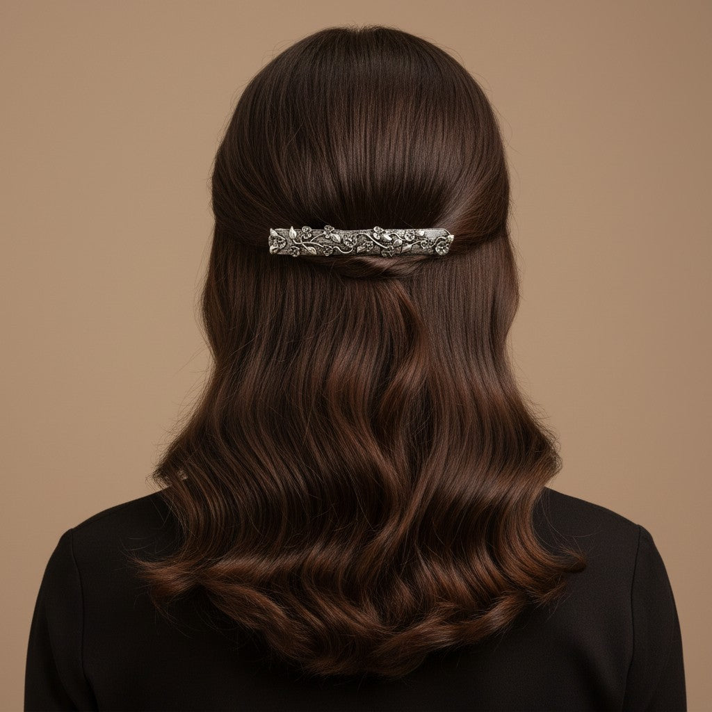 SHE BEAUTY vintage metallic barrette with intricate vine and floral detailing worn in long wavy brown hair