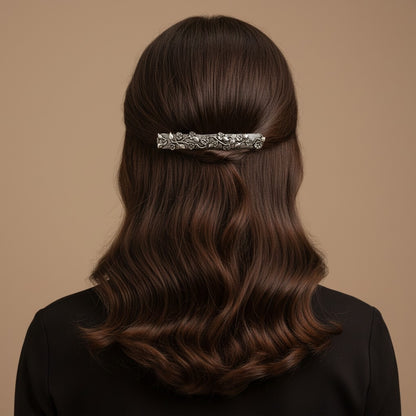 SHE BEAUTY vintage metallic barrette with intricate vine and floral detailing worn in long wavy brown hair
