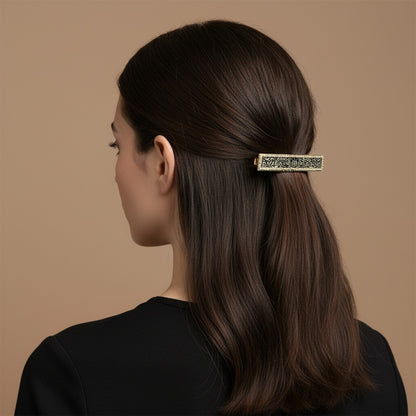 SHE BEAUTY vintage metallic barrette with intricate lace-inspired detailing worn in a woman's dark hair