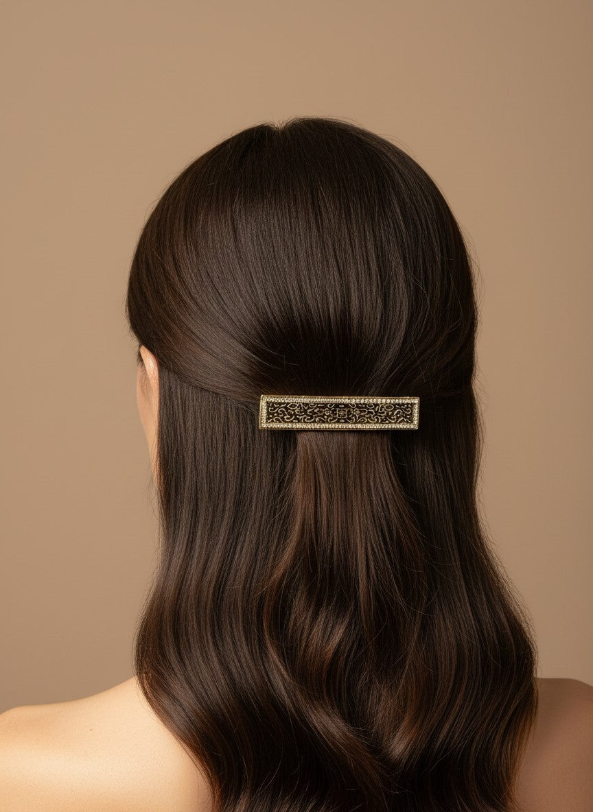 SHE BEAUTY vintage metallic barrette with intricate lace-inspired detailing worn in dark hair