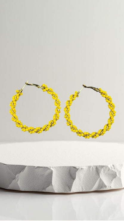 SHE BEAUTY GIRISH CRYSTAL BALI hoop earrings featuring bright yellow beaded wire wrapped in a circular design