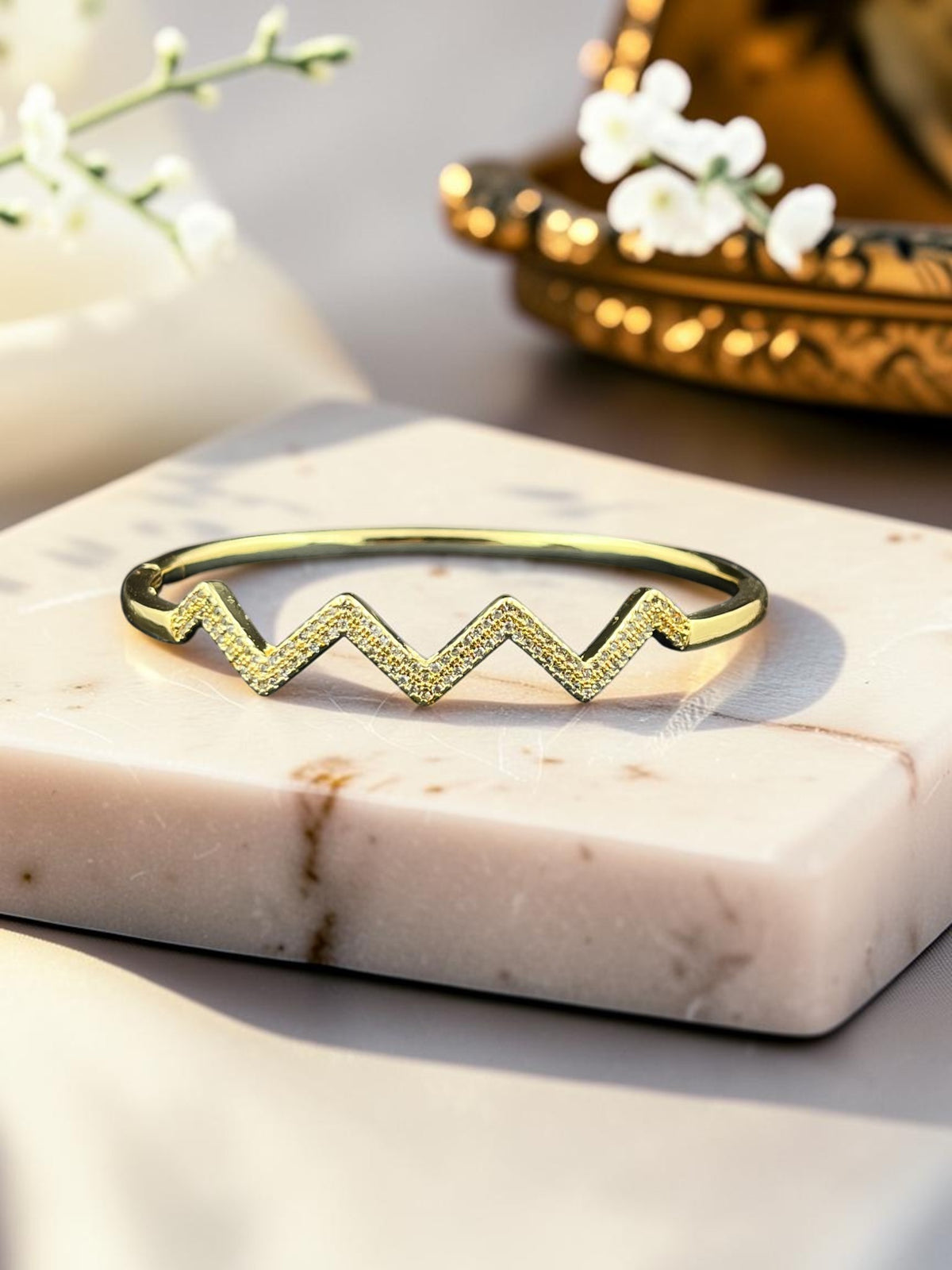 SHE BEAUTY anti-tarnish gold-tone bracelet featuring a modern zigzag design with sparkling AD stones
