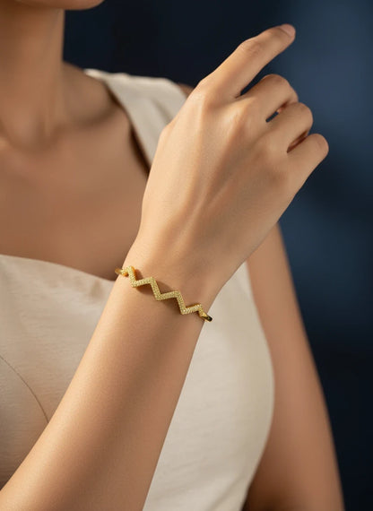 SHE BEAUTY anti-tarnish gold-tone bracelet with a modern zigzag design worn on a woman's wrist