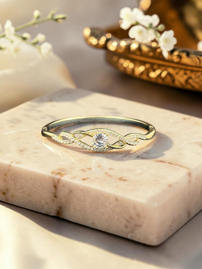 SHE BEAUTY anti-tarnish gold bracelet featuring a central zirconia stone and intricate twisted pave-set band design.