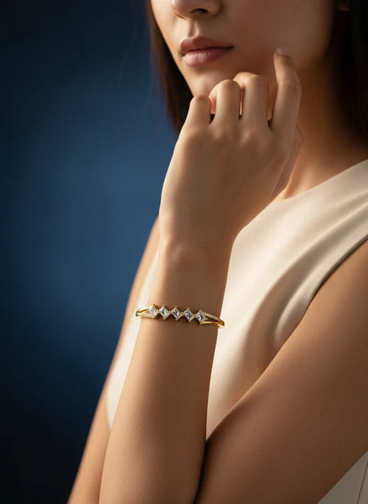 SHE BEAUTY gold-toned anti-tarnish bracelet featuring square zirconia stones worn on a woman's wrist