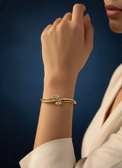 SHE BEAUTY anti-tarnish gold bracelet featuring sparkling zirconia stones in a stylish bypass design on a wrist.