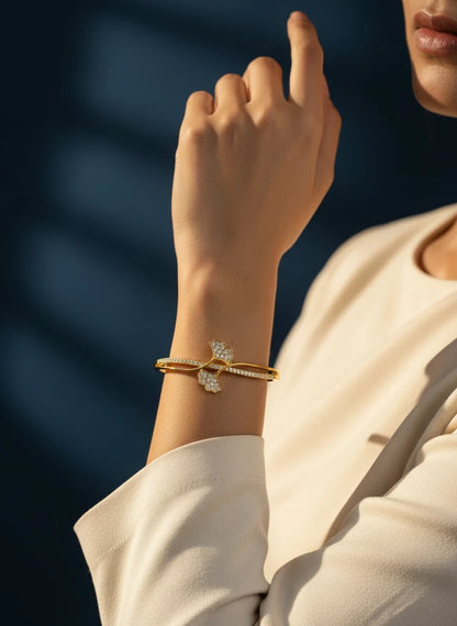 SHE BEAUTY anti-tarnish gold bracelet with sparkling zirconia stones in a delicate floral design on a woman's wrist.