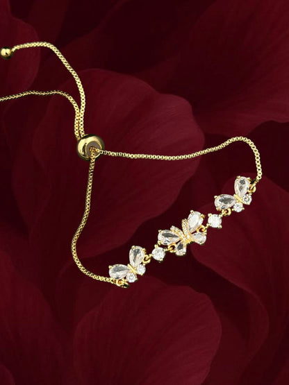 SHE BEAUTY Zirconia Wings bracelet featuring gold-tone chain and sparkling butterfly-shaped crystal charms.